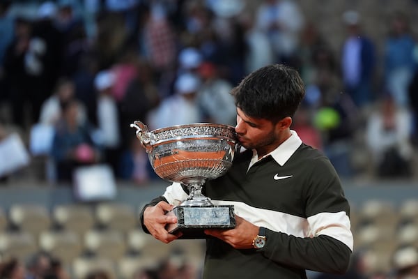 Spain's Carlos Alcaraz celebrates with the trophy after winning the final match of the French Tennis Open against Italy's Jannik Sinner at the Roland-Garros stadium in Paris, Sunday, June 8, 2025. (AP Photo/Lindsey Wasson)