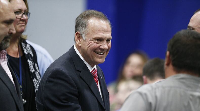 Former Alabama Chief Justice and U.S. Senate candidate Roy Moore walks out after he speaks at a revival, Tuesday, Nov. 14, 2017, in Jackson, Ala. (AP Photo/Brynn Anderson)