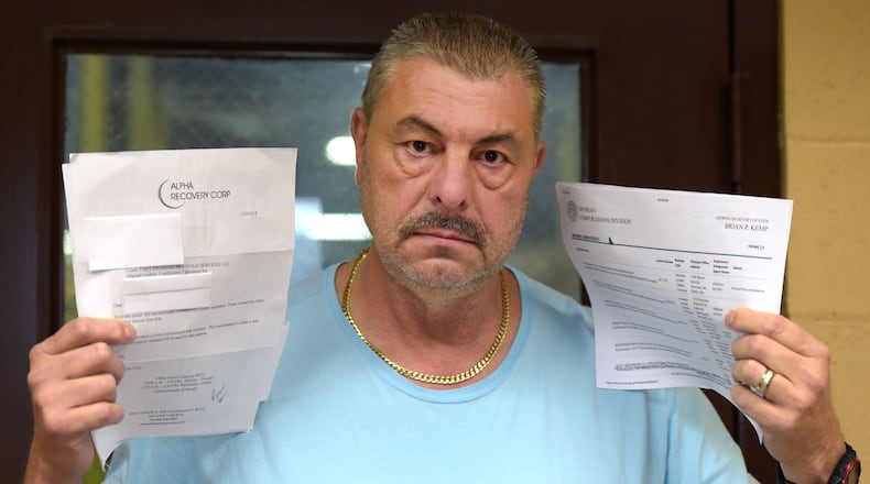 Greensboro, Ga., resident Michael Rowe holds up the paperwork and research he did on Confirmatrix Laboratory Inc. Earier this year he started getting calls from debt collectors claiming he owed money for lab work done in 2014. JENNA EASON / JENNA.EASON@COXINC.COM