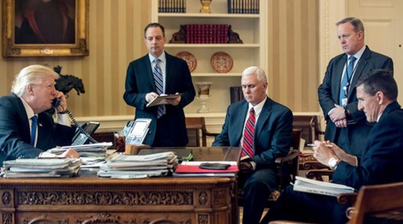 In this Jan. 28, 2017, file photo, President Donald Trump's inner circle during the early days of his presidency, from second from left, Chief of Staff Reince Priebus, Vice President Mike Pence, White House press secretary Sean Spicer and National Security Adviser Michael Flynn speaks on the phone with Russian President Vladimir Putin in the Oval Office at the White House in Washington. Flynn resigned as President Donald Trump's national security adviser Monday, Feb. 13, 2017.