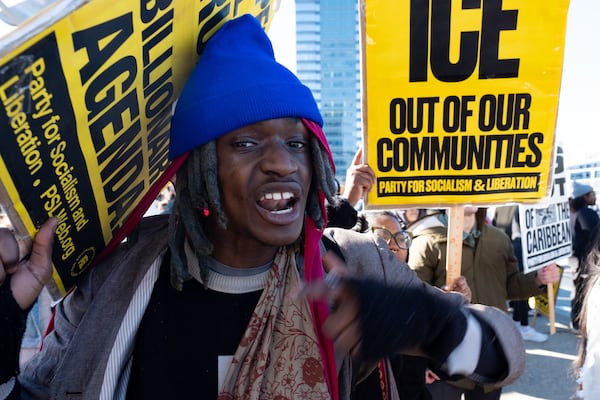Michael “Overpade” Malachi chants along with others on the 17th Street Bridge in Atlanta on Sunday, Jan. 11, 2026 during a protest against the ICE shooting of Renee Good and the US military action in Venezuela. Ben Gray for the Atlanta Journal-Constitution