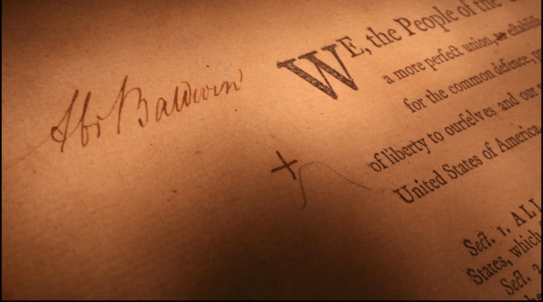 Georgia's original copy of the U.S. Constitution, with Abraham Baldwin's signature and notes visible.