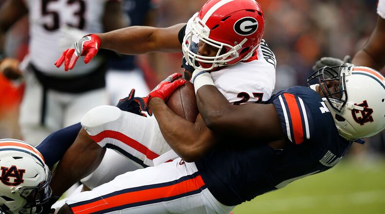 Georgia running back Nick Chubb is tackled by Auburn linebacker Jeff Holland during the first half Nov. 11, 2017, in Auburn, Ala. Just three weeks after Auburn romped to a 23-point victory, the No. 4 Tigers face a rematch against No. 6 Georgia in the Southeastern Conference championship game. (Brynn Anderson/AP)