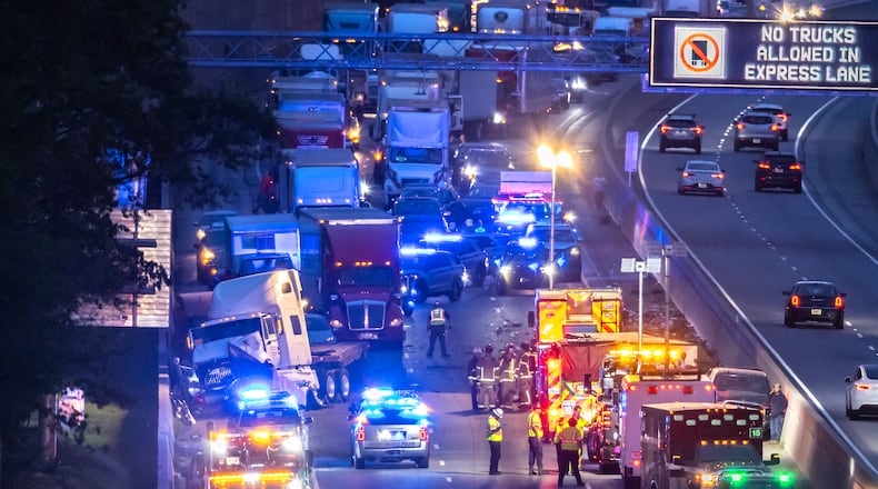 All lanes reopened on I-75 South in Henry County after a six hour investigation of a deadly crash involving multiple tractor-trailers that brought travel to a standstill Tuesday morning, April 16, 2024. The collision happened near mile marker 221, or just past Jodeco Road and before Jonesboro Road, at around 4:40 a.m., according to the Georgia Department of Transportation. The lanes were cleared by 11:20 a.m., GDOT stated, though traffic remained backed up for miles. Henry police confirmed at least one fatality. They did not release additional information about the extent of any other injuries. After the crash, a crane was used to lift a vehicle that appeared to have been pinned under one of the tractor-trailers. Several other big rigs remained on the shoulder of the interstate during the cleanup efforts. Police did not share details about what led to the wreck, as investigators processed the scene. Motorists were told to avoid the area. Backups extended for several miles, reaching I-675 as of 11:30 a.m. Commuters used U.S. 19/41, Ga. 42 and Ga. 155 as alternates, though traffic on those roads moved slowly, according to the WSB 24-hour Traffic Center. (Photo by John Spink/AJC)