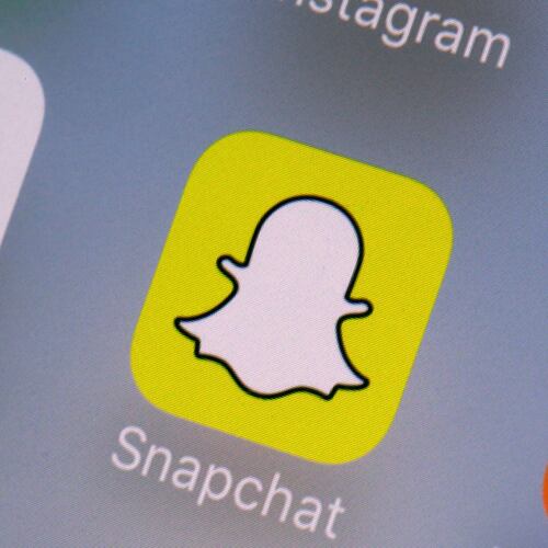 FILE- This Aug. 9, 2017, file photo shows the Youtube, left, and Snapchat apps on a mobile device in New York. (AP Photo/Richard Drew, File)