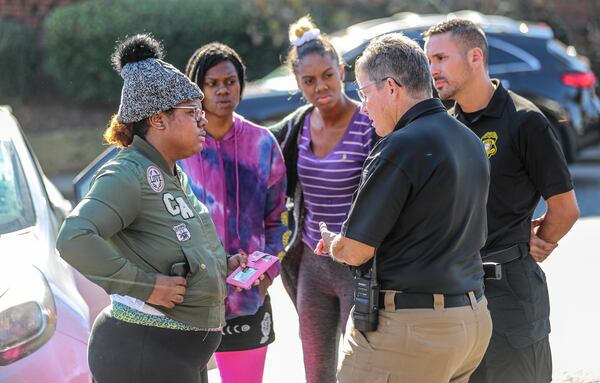 November 2021 DeKalb County: Deonna Bray (left) speaks with Clarkston Police Chief Christine Hudson (2nd from right) about news on Bray's missing son, 1-year old Blaise Barnett, who was taken when the car he was in was stolen while his parents were unloaded groceries. The baby was found 36 hours later when a neighbor found him in a car about a mile from where abduction occurred. (John Spink / John.Spink@ajc.com)


