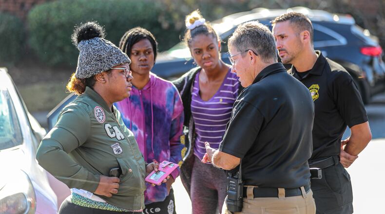 Deonna Bray (left) speaks with Clarkston police Chief Christine Hudson (second from right) during the search for Bray's missing 1-year old, Blaise Barnett. It's been one week since the mother and child were reunited, and Clarkston police said they have not identified any suspects.