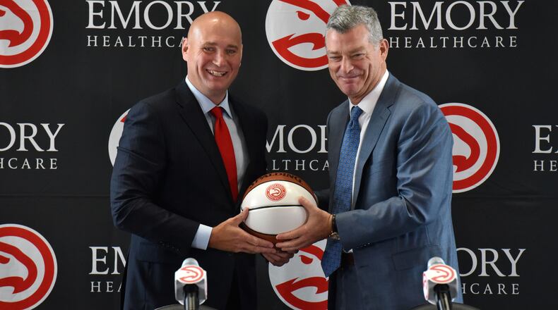 New Hawks GM Travis Schlenk (left) and Hawks principal owner Tony Ressler hold a basketball during an introductory press conference on Friday, June 2, 2017. HYOSUB SHIN / HSHIN@AJC.COM