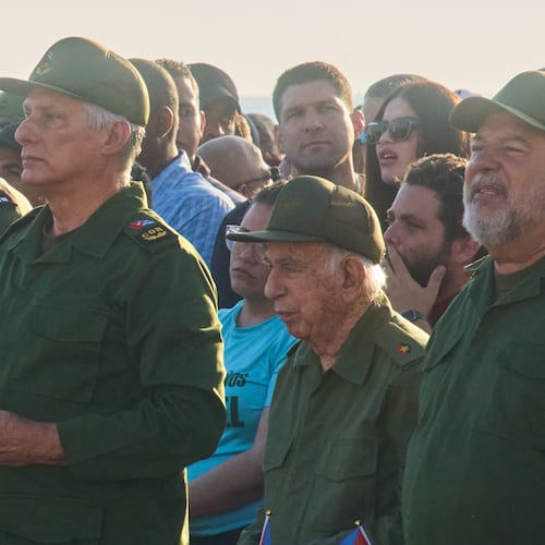 Cuba's President Miguel Diaz-Canel, second left, and Raul Castro's grandson Raul Guillermo Rodriguez Castro, center back, take part in a rally in support of former President Raul Castro in front of the U.S. Embassy in Havana, Cuba, Friday, May 22, 2026, after U.S. prosecutors filed an indictment accusing him of ordering the 1996 shootdown of civilian planes flown by Miami-based exiles. (AP Photo/Ramon Espinosa)