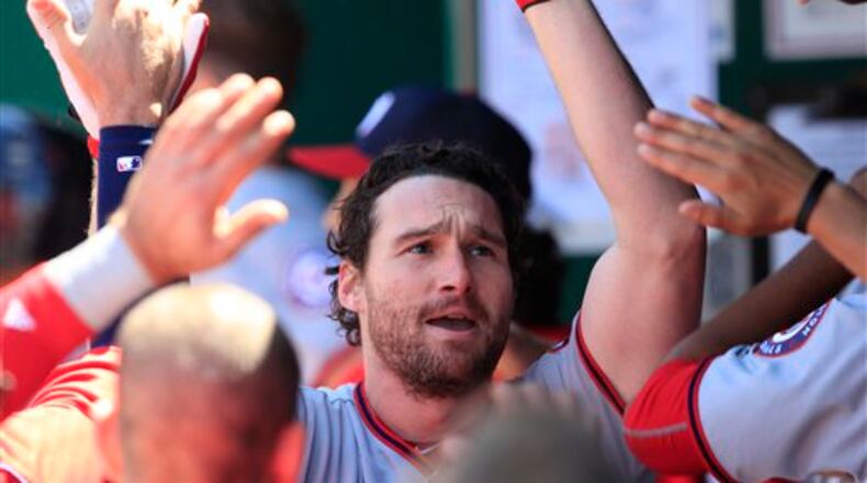 Washington Nationals' Daniel Murphy is congratulated by teammates after his solo home run during the fourth inning of a baseball game against the Kansas City Royals at Kauffman Stadium in Kansas City, Mo., Wednesday, May 4, 2016. (AP Photo/Orlin Wagner)