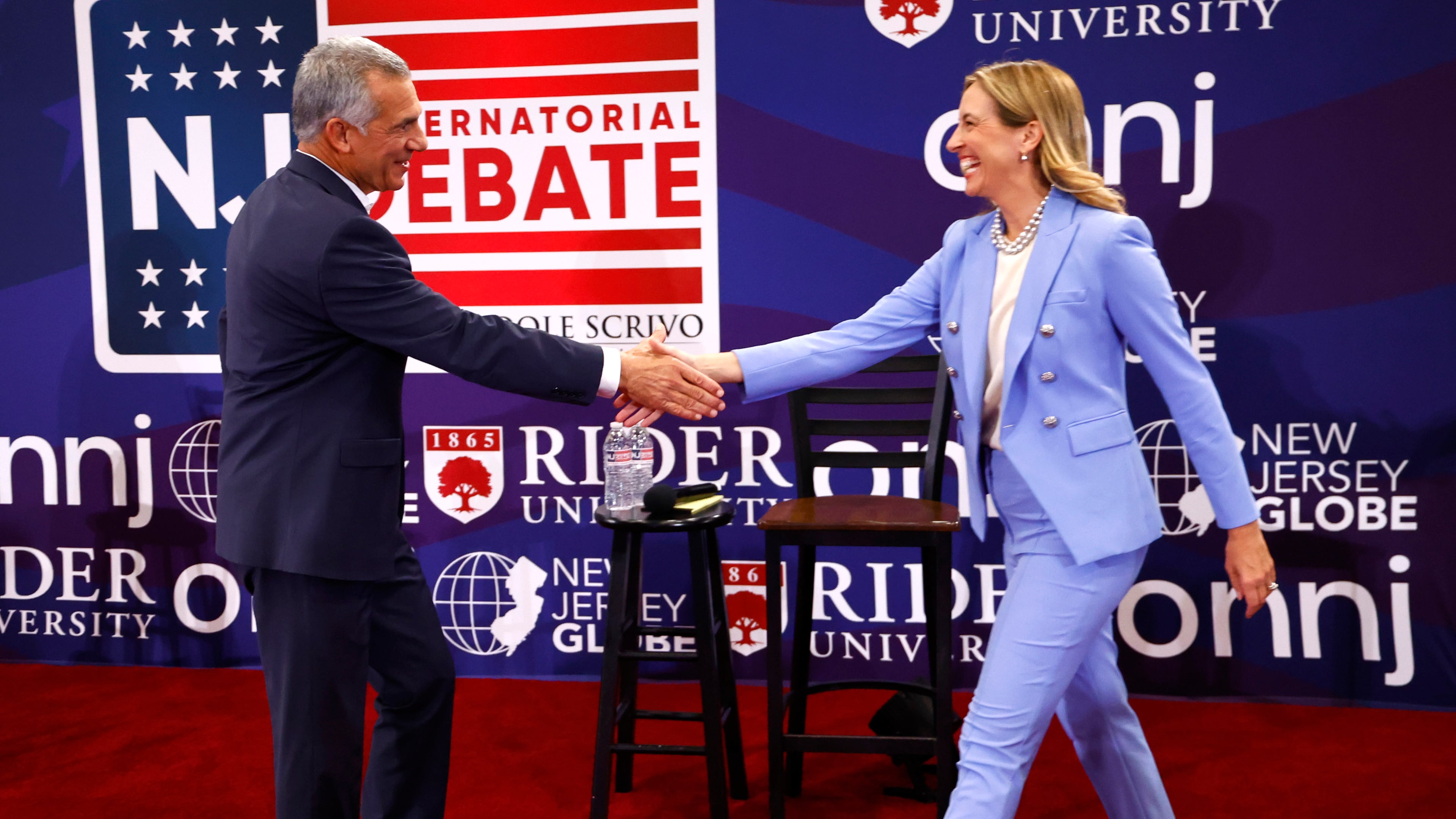 Republican candidate Jack Ciattarelli, left, shake hands with Democratic candidate for governor Mikie Sherrill, right, and before debate Sunday, Sept. 21, 2025, in Lawrenceville, N.J. (AP Photo/Noah K. Murray)