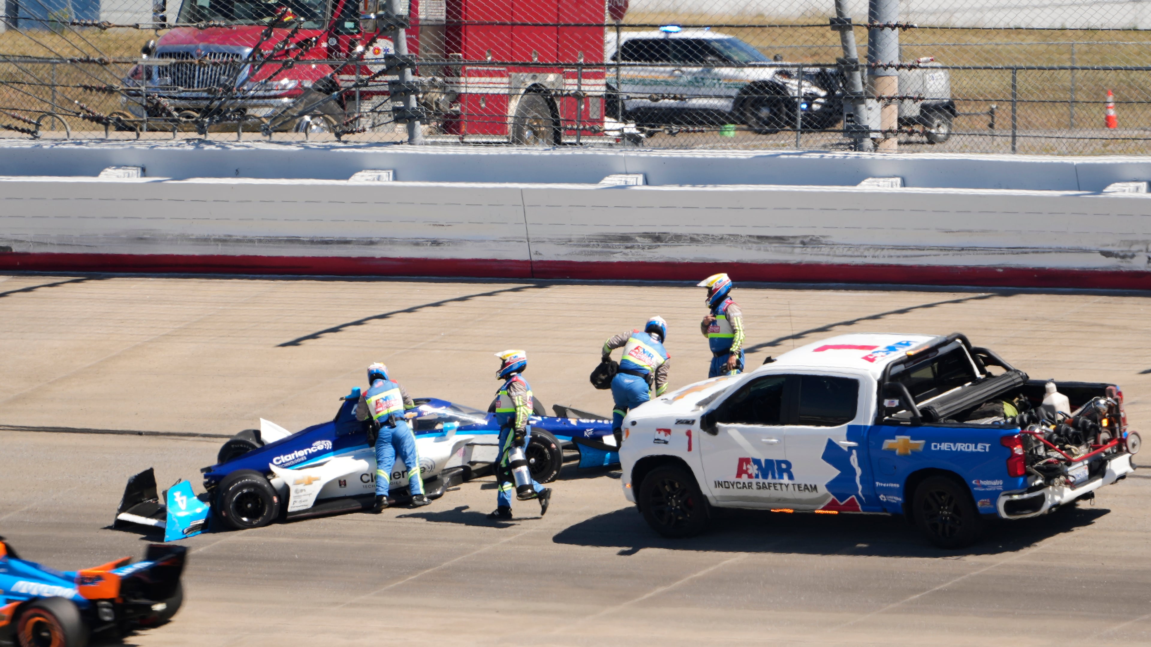 David Malukas (4) is helped by track personnel after his crash during an IndyCar auto race Sunday, Aug. 31, 2025, at Nashville Superspeedway in Lebanon, Tenn. (AP Photo/George Walker IV)