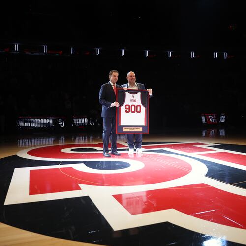 St. John's head coach Rick Pitino, left, is presented with a jersey by Ed Kull for his 900th win before an NCAA college basketball game against Butler, Wednesday, Jan. 28, 2026, in New York. (AP Photo/Heather Khalifa)