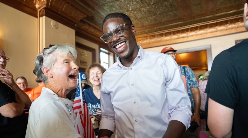 David Crowley, Democratic candidate for Wisconsin governor, shakes hands with Karen Hilt, left, during a campaign stop Friday, Aug. 7, 2026, in Sheboygan, Wis. (AP Photo/Kayla Wolf)