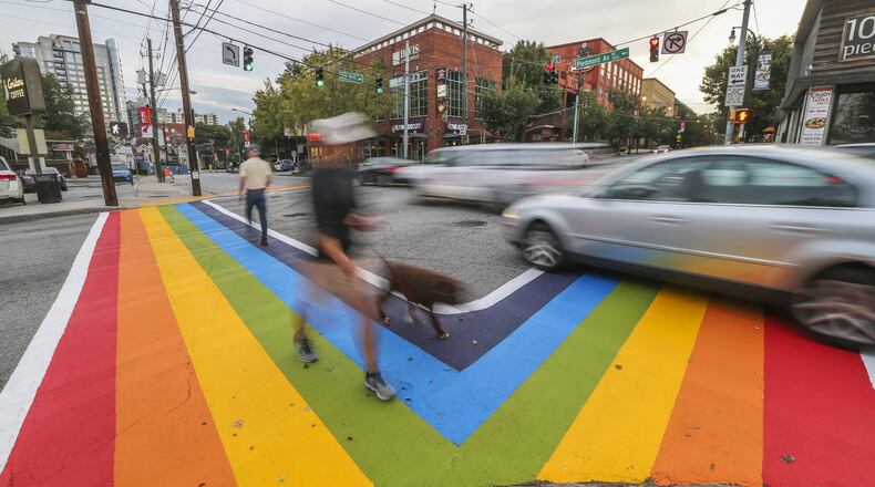 October 9, 2015 Atlanta: Motorists and pedestrians had a brand new perspective of 10th and Piedmont Avenue on Friday morning, Oct. 9, 2015 as the project to paint rainbow crosswalks in Midtown for the launch of Atlanta Pride that began late Thursday was completed. The colors won’t last forever. The city, citing safety concerns and state regulations, said the design cannot be permanent. It’s a decision that Robert Sepulveda, president of the Atlanta Rainbow Crosswalks, and other organizers want reversed. Sepulveda, whose organization uses public art to promote diversity, contends Mayor Kasim Reed’s office reneged on an initial pledge to allow the design for Atlanta Pride weekend to be permanent. “They told us it would be a permanent installation to the city of Atlanta’s art collection,” Sepulveda told Channel 2 Action News. “Midtown is the epicenter for the LGBT community so it just makes sense.” JOHN SPINK /JSPINK@AJC.COM