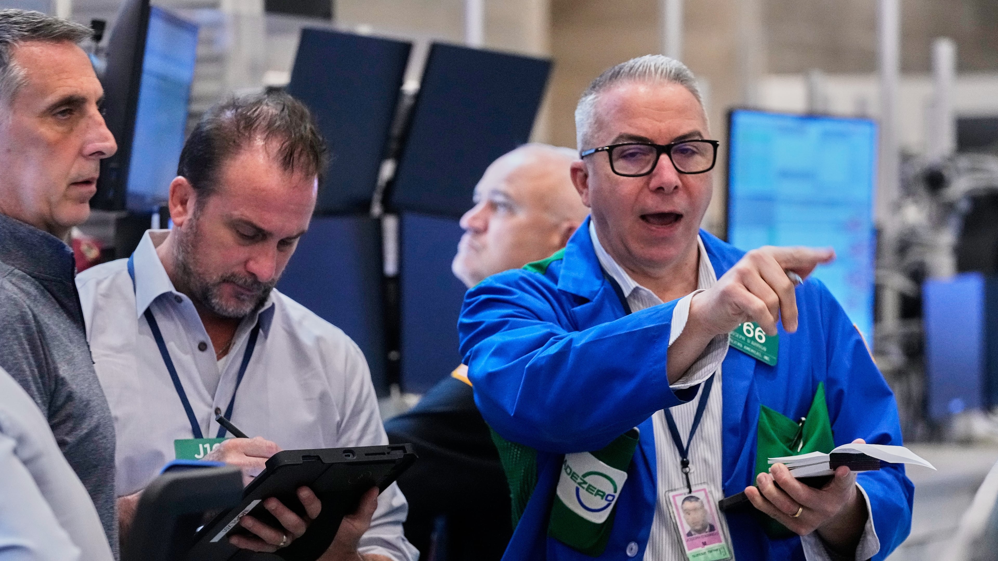 Options traders Joseph Arrigo, right, works on the floor of the New York Stock Exchange, Monday, Oct. 20, 2025. (AP Photo/Richard Drew)