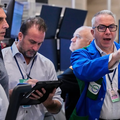 Options traders Joseph Arrigo, right, works on the floor of the New York Stock Exchange, Monday, Oct. 20, 2025. (AP Photo/Richard Drew)