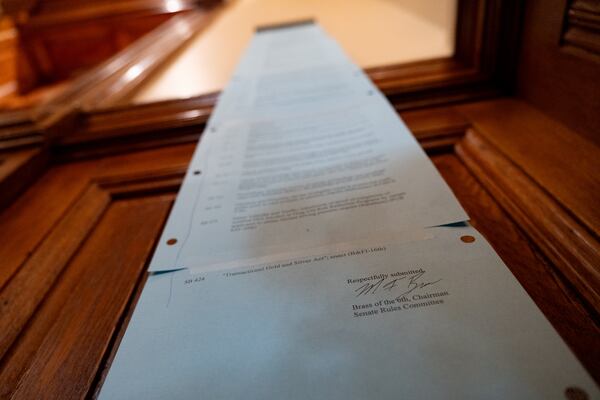 A six-page list of bills to be tackled in the Senate hangs beside the chamber door during Crossover Day at the Georgia Legislature in Atlanta on Friday, March 6, 2026. (Ben Gray for the AJC)