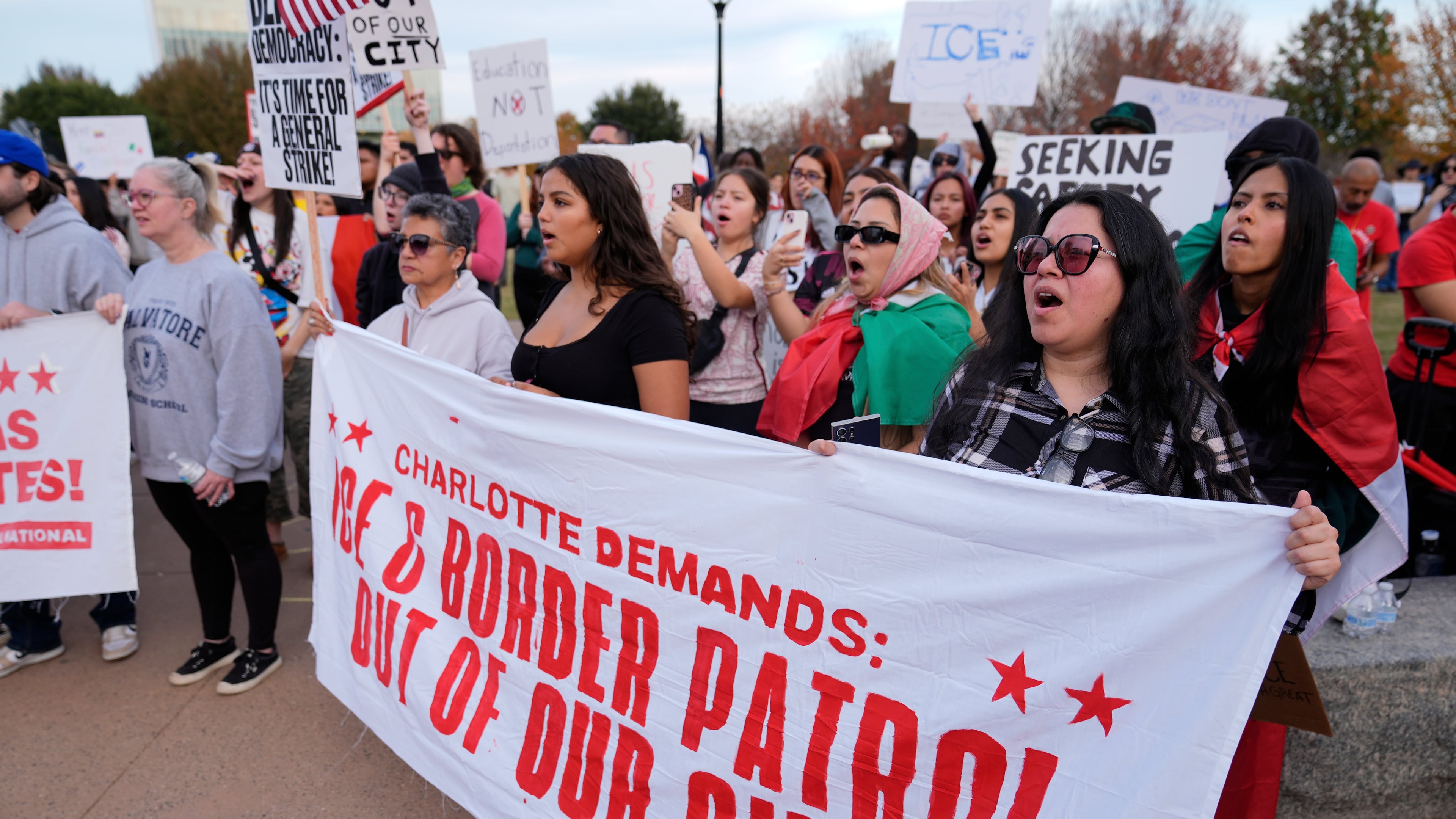 People protest against federal immigration enforcement Saturday, Nov. 15, 2025, in Charlotte, N.C. (AP Photo/Erik Verduzco)