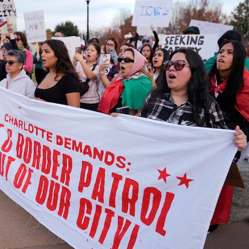 People protest against federal immigration enforcement Saturday, Nov. 15, 2025, in Charlotte, N.C. (AP Photo/Erik Verduzco)