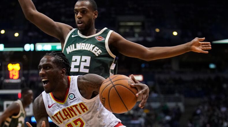Atlanta Hawks' Taurean Prince drives past Milwaukee Bucks' Khris Middleton during the second half of an NBA basketball game Saturday, March 17, 2018, in Milwaukee. (AP Photo/Morry Gash)