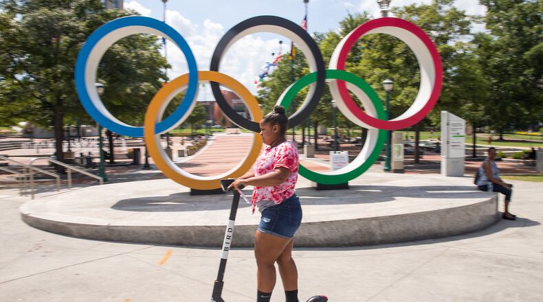 08/20/2019 -- Atlanta, Georgia -- A woman rides a sharable e-scooter near Centennial Olympic Park in Atlanta, Tuesday, August 20, 2019. (Alyssa Pointer/alyssa.pointer@ajc.com)