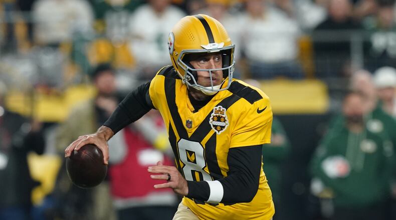 Pittsburgh Steelers' Aaron Rodgers scrambles during the first half of an NFL football game against the Green Bay Packers Sunday, Oct. 26, 2025, in Pittsburgh. (AP Photo/Matt Freed)