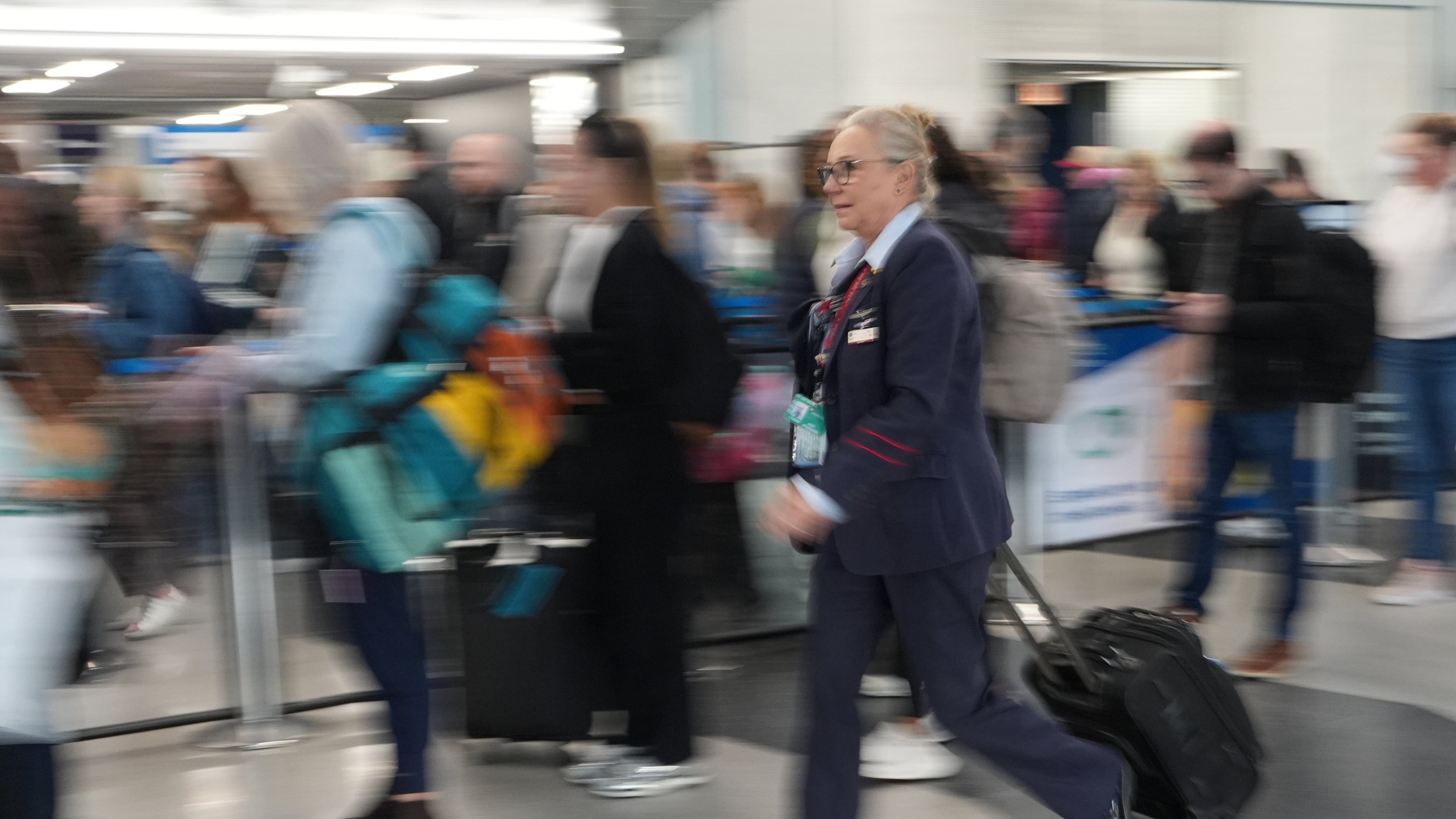 Travelers line up at a TSA check at O'Hare International Airport in Chicago, Friday, Nov. 7, 2025. (AP Photo/Nam Y. Huh)