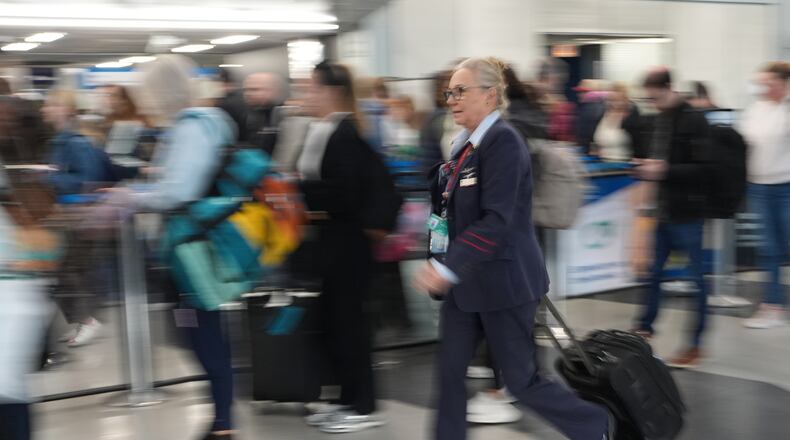 Travelers line up at a TSA check at O'Hare International Airport in Chicago, Friday, Nov. 7, 2025. (AP Photo/Nam Y. Huh)