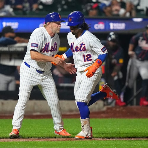 New York Mets third base coach Tim Leiper, left, celebrates with Francisco Lindor as he runs the bases after hitting a three-run home run during the eighth inning of a baseball game against the Atlanta Braves Monday, July 27, 2026, in New York. (AP Photo/Frank Franklin II)