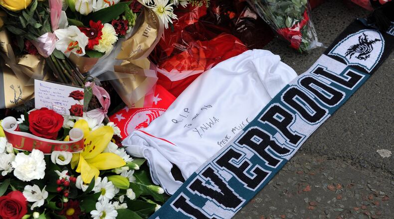 FILE -Tributes are laid at the memorial of the Hillsborough disaster outside Anfield before the English Premier League soccer match between Liverpool and Manchester City at Anfield in Liverpool, England, April. 13, 2014. (AP Photo/Clint Hughes, File)