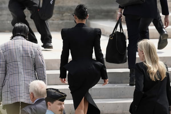 Kim Kardashian, center, walks up the steps of the palace of justice as she arrives to testify regarding a robbery of millions of dollars in jewels from her Paris hotel room in 2016, in Paris, Tuesday, May 13, 2025. (AP Photo/Aurelien Morissard)