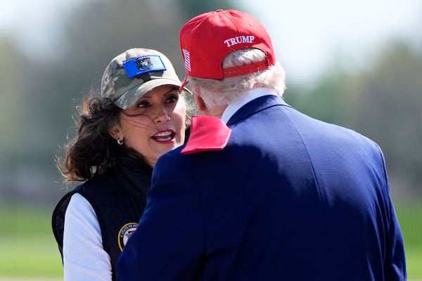 Michigan Gov. Gretchen Whitmer greets President Donald Trump as he arrives on Air Force One at Selfridge Air National Guard Base, Tuesday, April 29, 2025, in Harrison Township, Mich. (AP Photo/Alex Brandon)