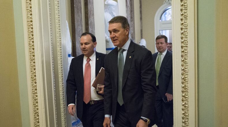 U.S. Sens. Mike Lee, R-Utah, left, and David Perdue, R-Ga., arrive for a closed-door meeting about the Senate health care bill Thursday in Washington. Senate Republicans took a major step Thursday toward repealing and replacing the Affordable Care Act, unveiling a bill that would make deep cuts to Medicaid and end the mandate that most Americans have health insurance. (PHOTO by Doug Mills/The New York Times)