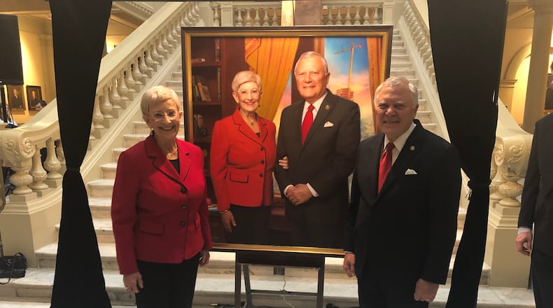 Sandra Deal and Gov. Nathan Deal pose by an official portrait unveiled at the Georgia Capitol. AJC/Greg Bluestein