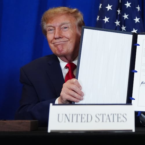 President Donald Trump holds up the document after signing a security agreement with Denmark's Prime Minister Mette Frederiksen and Greenland's Prime Minister Jens-Frederik Nielsen during the United Nations General Assembly, Tuesday, Sept. 22, 2026, at the UN headquarters. (AP Photo/Julia Demaree Nikhinson)