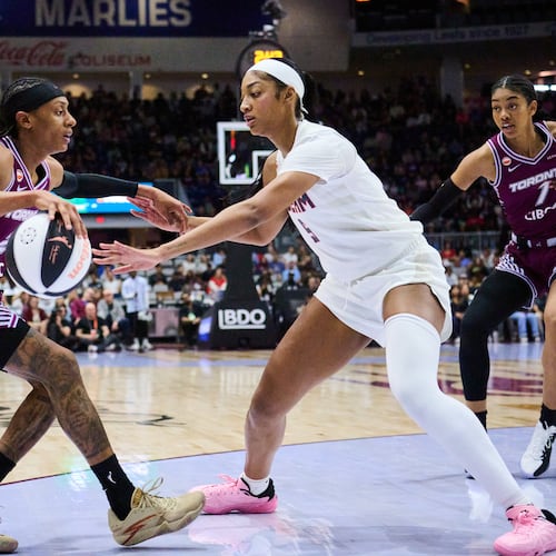 Toronto Tempo's Brittney Sykes, left, keeps the ball from Atlanta Dream's Angel Reese, second from left, during the first half of a WNBA basketball game in Toronto, Sunday, June 14, 2026. (Sammy Kogan/The Canadian Press via AP)