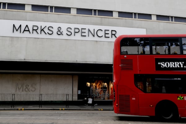FILE - A bus passes a branch of Marks and Spencer in London, Tuesday, Aug. 18, 2020. (AP Photo/Kirsty Wigglesworth, file)