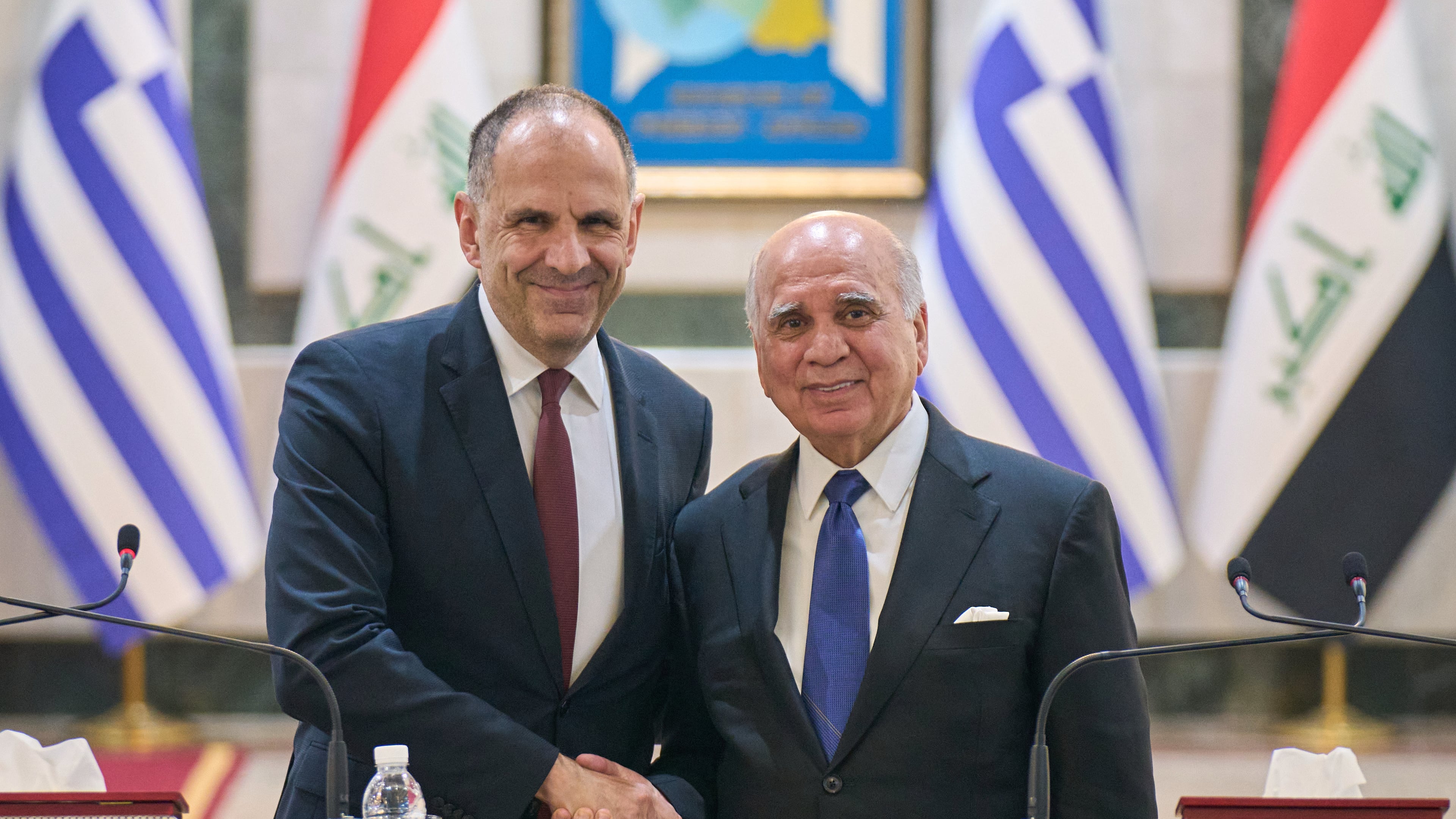 Iraqi Foreign Minister Fuad Hussein, right, shakes hands with his Greek counterpart George Gerapetritis, in Baghdad, Iraq, Thursday, Oct. 30, 2025. (AP Photo/Hadi Mizban)