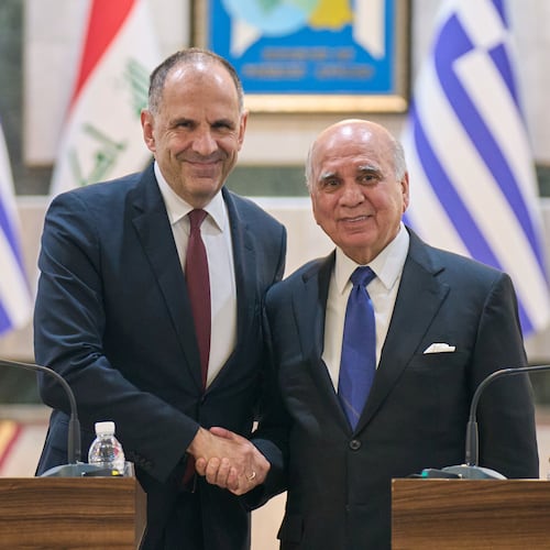 Iraqi Foreign Minister Fuad Hussein, right, shakes hands with his Greek counterpart George Gerapetritis, in Baghdad, Iraq, Thursday, Oct. 30, 2025. (AP Photo/Hadi Mizban)