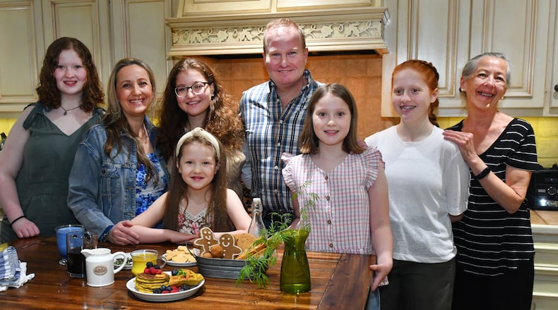 Health concerns in her family helped push Cristina Kisner, a mom of five daughters, toward cooking. She went on to own Cristy’s Kitchen in Roswell. The family includes (from left) Gala Gracey, Kisner, Camila Gracey, Hebe Gracey (in front of Camila), husband Sebastian Gracey, Josefina Gracey, Julieta Gracey and Laura Gylling (Kisner's mother). (Styling by Cristina Kisner / Chris Hunt for the AJC)