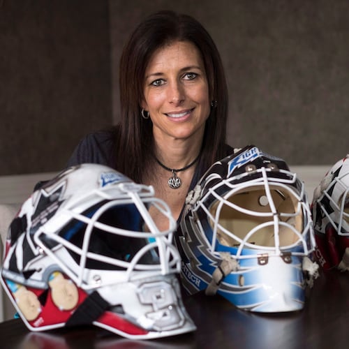 FILE - Former professional goaltender Manon Rheaume poses for a photograph with three of her masks Wednesday, Nov. 2, 2016 in Detroit. (Paul Chiasson/The Canadian Press via AP)