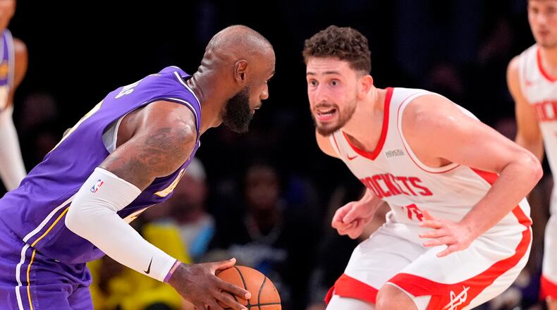 Los Angeles Lakers forward LeBron James, left, tries to get by Houston Rockets center Alperen Sengun during the second half in Game 5 of a first-round NBA playoffs basketball series Wednesday, April 29, 2026, in Los Angeles. (AP Photo/Mark J. Terrill)