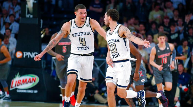 Georgia Tech guard Jordan Usher (4) reacts with guard Jose Alvarado (10) during the first half of an NCAA college basketball game against Louisville in Atlanta, Wednesday, Feb. 12, 2020. (AP Photo/Todd Kirkland)