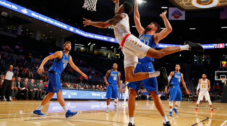 Atlanta Hawks forward John Collins (20) goes up to shoot as Dallas Mavericks center Jeff Withey (17) defends in the first half of an NBA preseason basketball game Thursday, Oct. 12, 2017, in Atlanta. (AP Photo/Todd Kirkland)