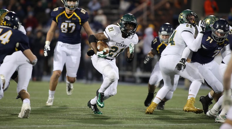 Blessed Trinity running back Elijah Green (21) runs for yardage in the first half against Marist during the Class AAAA Championship game at Marist School Friday, December 15, 2017, in Atlanta.