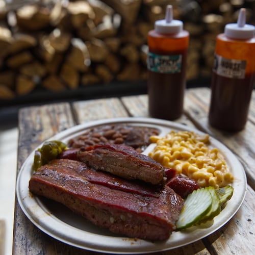 A plate of ribs and sausage with two sides is served at the Little Miss BBQ in Phoenix, Tuesday May 19, 2026. (AP Photo/Dario Lopez-Mills)