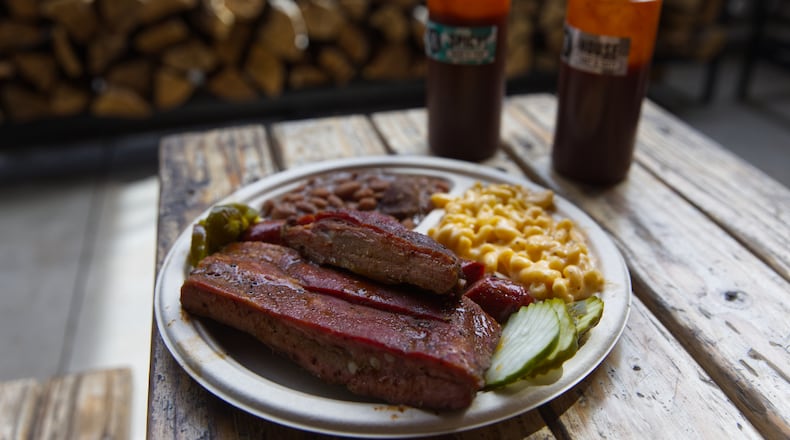 A plate of ribs and sausage with two sides is served at the Little Miss BBQ in Phoenix, Tuesday May 19, 2026. (AP Photo/Dario Lopez-Mills)