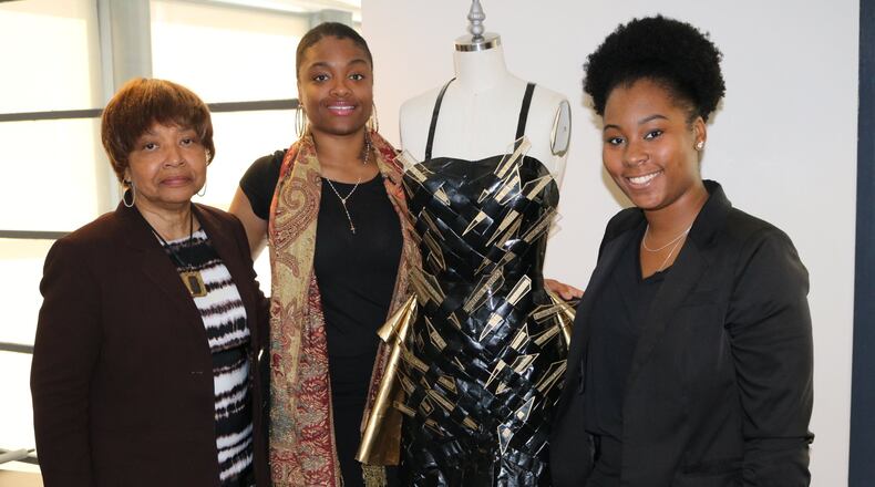 Fashion designer and Clark Atlanta University senior lecturer Cynthanie Sumpter (far left) conceptualized this dress in memory of Jewish designers and employees in the fashion industry in Berlin, Germany, persecuted or killed by the Nazis. Clark Atlanta fashion design students Le’Nora Gray (center) and Niambi Davenport assisted in creating the dress. CONTRIBUTED
