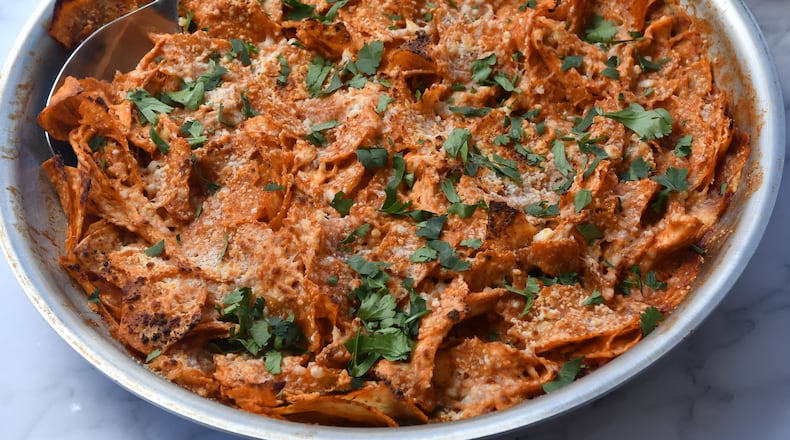 These Chicken Chilaquiles are topped with cotija cheese and chopped fresh cilantro, but you can dress them up even more. (Chris Hunt for The Atlanta Journal-Constitution)